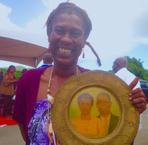 Meloma Lewis proudly displays a plaque of her grandparents, Paul E. and Elaine Joseph, during the groundbreaking for the Paul E. Joseph Stadium.