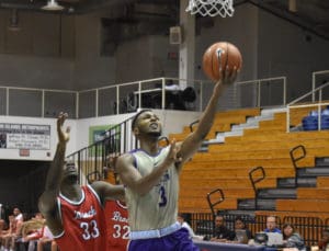 Dukes guard Matt Lewis scores two of his 16 points against the Ravens.