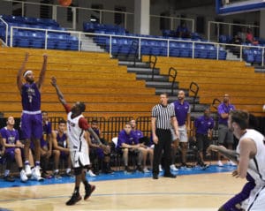 JMU freshman guard Matt Lewis launches a three-pointer over Carleton.