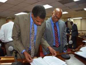 Finance Committee Chairman Sen. Kurt Vialet and Commissioner of Property and Procurement Lloyd Bough look through budget information. 