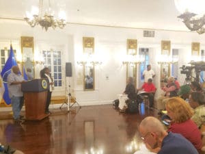 Gov. Kenneth Mapp, at the far left, gives his daily update on hurricane recovery efforts to the gathered news media. The update took place at Government House on St. Croix.