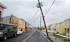 A power pole tilts precariously over Queen Street in Frederiksted. (Photo from Angel Santiago's Facebook page) 