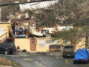 The roof of this building appears to have been scattered across the surround hillside. (Love City Strong)