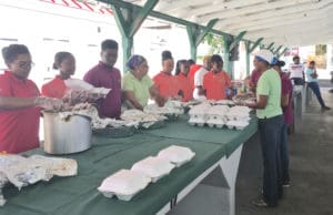 Student Ambassadors from UVI's 4-H Youth Development pack and serve food.