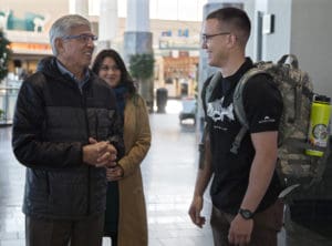 Alaska's Lt. Gov. Byron Mallot talks to Spc. Michael Notti, a paralegal specialist assigned to the 297th Infantry Battalion, Alaska Army National Guard, at Ted Stevens International Airport, Anchorage before the Notti and more than 50 other Guardsmen ship out for the U.S. Virgin Islands. (Alaska Army National Guard photo by 2nd Lt. Marisa Lindsay)