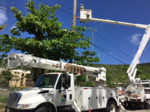 A line crew from BBC Electrical Services of Joplin, Missouri, connects a home to the newly energized power grid on St. John.