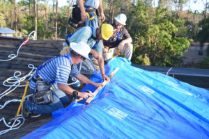 Contractors install roofting material for Project Blue Roof in this Florida photo from the Army Corps of Engineers.