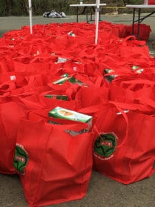 Bright red bags of goods from Tim Duncan's 21 USVI Hurricane Help are lined up in Frederiksted on Sunday. (Ivy Hunter photo)