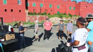 CZM's Kristina Edwards instructs a cleanup crew as it prepares to work its way through Charlotte Amalie Saturday.