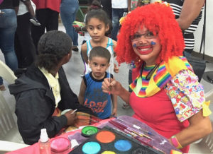 Patsy the Clown paints children’s faces for Gov. Kenneth Mapp’s Christmas party Wednesday on St. Croix.