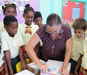Fourth grade teacher Lisa Magras opens a box of school supplies for her class at Pearl B. Larsen Elementary School. (Photo from the V.I. Department of Education)
