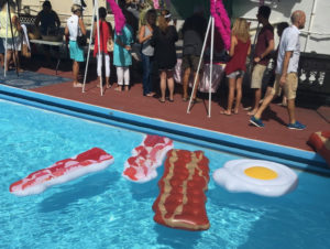 Bacon floats line the pool as attendees sample the various dishes. (Photo by David Schnur)