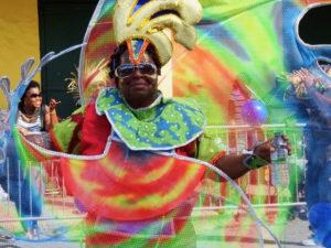 A parade participant is resplendent in tie dye as she cruises down the parade route Sturday. (Anne Salafia photo)