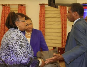 Sen. Kurt A. Vialet talks with Commissioner of Education Sharon McCollum during a break in Wednesday's Committee on Education, Youth and Recreation meeting. Dionne Wells-Hendrington, insular superintendent for the St. Thomas-St. John, looks on. (V.I. Legislature photo)