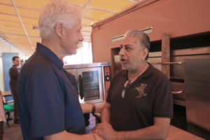 Former President Bill Clinton meets with community members, including India Association president Pash Daswani, to talk about hurricane recovery issues.