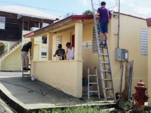 Volunteers from Christ Memorial Church in Williston, Vermont, paint the Lighthouse Mission. (Susan Ellis photo)