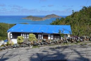 A damaged St. Thomas home with a blue tarp roof in March of 2018. (Bill Kossler photo)