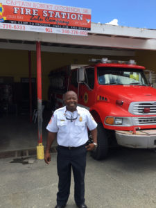 Deputy Chief Ernest Matthias in front of the Cruz Bay fire station that still serves as a garage for fire trucks.