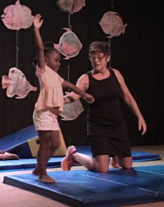 Jude Woodcock guides young students through moves in Flip Flop Class, a beginning class in tumbling.