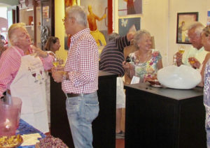 Frank Machover, left, extols the virtues of a cool, crisp rose’ in the tropical climate. Third from right, Chantal charms guests at a Mango Tango wine tasting.