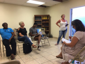Site manager Nancy Clendenin, standing, updates tenants at the meeting Tuesday. Seated, from left, are Christine Charles Laurent, Mary Castle Bartolucci, Kenisha Small, and Keryn Bryan.