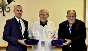 Billy Bohlke, left, and his father, Bill Bohlke Sr., accept Sapphire Pegasus awards from Bud Slabbaert of St. Martin, founder the Caribbean Aviation Meetup. (Photo by Kemuel Stubbs)
