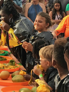 Peyton Schindler grins Sunday after finishing her fourth mango to win the children's division of the Mango Eating Contest at Mango Melee.