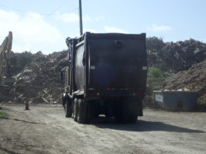 Truck hauls trash at St. Croix's Anguilla landfill. (Susan Ellis photo)