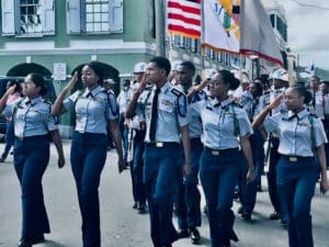 JROTC members snap a salute to the dignitaries in the parade reviewing stand.