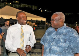 Gov. Kenneth Mapp and Lt. Gov. Osbert Potter smile and laugh in the official Government House photo from a government sponsored forum in Estate Tutu. The taxpayer-funded Government House statement is headlined "Recovery Successes Cited by Governor at Packed Town Hall Meeting."