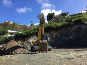 A backhoe clears Tier 2 property in Cruz Bay in January.