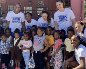 Members of the UCLA women's basketball team distribute new shoes and catch up with students at Joseph Gomez Elementary. (Photo by Jim Crawford, Basketball Travelers)