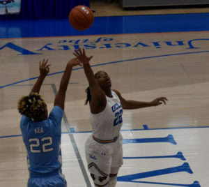 Paris Kea knocks down a three pointer over a UCLA defender in the first half of UNC’s victory at the UVI Sports and Fitness Center.