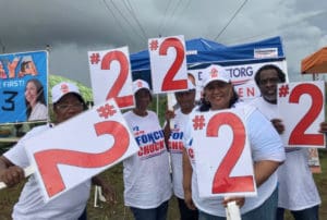 On St. Croix, adherents of the candidates line the streets outside the polling site at Juanita Gardine School.