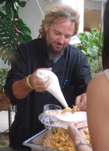 At the 2012 Taste of St. Croix, Eric 'Dreads' Nielsen exec chef of Savant, pipes wasabi onto scallops.