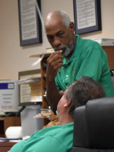 Board of Elections members Arturo Watlington Jr. and Robert “Max” Schanfarber take a break while counting votes after the general election.