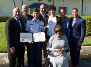 Lt. Ronaqua Russell surrounded by family, with her Air Medal. (U.S. Coast Guard photo) 