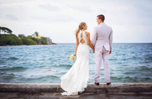 Working with their wedding planner, this is couple had to move their ceremony to a restaurant and rearranged their plans in two days. It took place the day before Hurricane Maria hit, and the bride's family had to ride out the storm on island. (Photo by Lindsay Kammerzelt Photography)