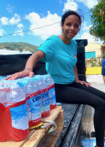 Love City Strong team member Joie Gerhardt waits to give away a case of water at the Coral Bay Fire Station.