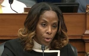 Delegate to Congress Stacey Plasket questions Michael Cohen Wednesday during the House Government Oversight Committee's hearing.