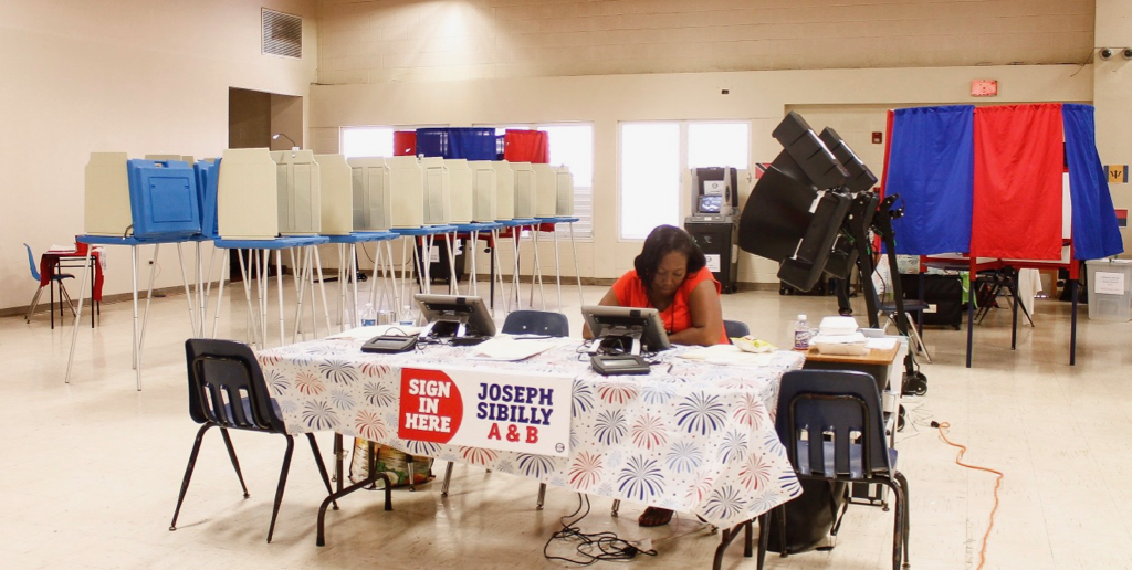 A Joseph Sibilly polling judge waits for voters at the Lockhart Elementary polling place on St. Thomas.