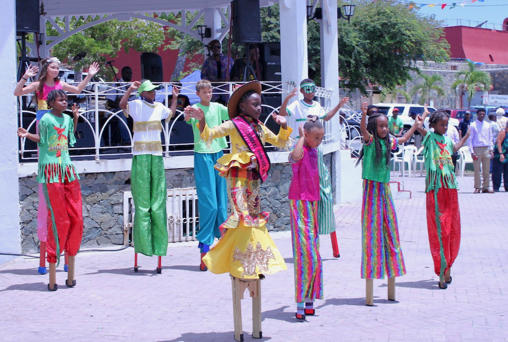 Culture Shock, a group of young moko jumbies, had nine performers in the Emancipation Garden wearing colorful outfits while boogeying on wooden stilts. (Bethaney Lee photo)