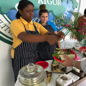 Raynesha Noel and Lily Porter serve JAVI guests at Gift Hill School. (Amy Roberts photo)