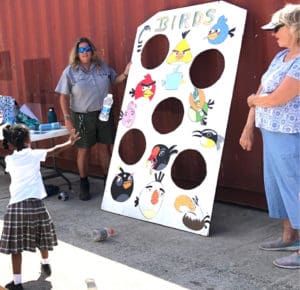 National Park Ranger Laurel Brannick has children throw bottles at a target to show how angry the birds are about plastic in the environment. (Photo by Gail Karlsson)