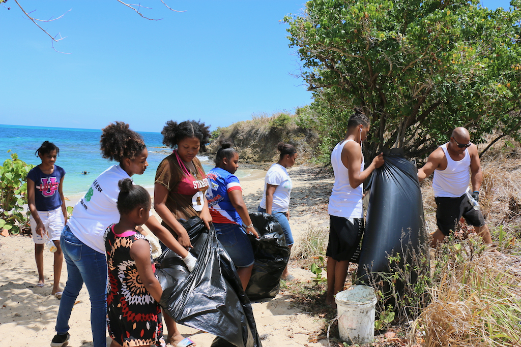 Some of the 12 to 14 people of all ages who worked together to gather and dispose of trash along the beach in preparation for the upcoming Easter camping. 4-H Ambassadors and Dominicans in Action Committee Members made up the volunteers. (Linda Morland photo)