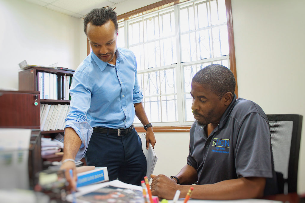 viNGN Chief Information Officer Daryl Wade, left, pores over a map with lead field technician Celestino White Jr.
