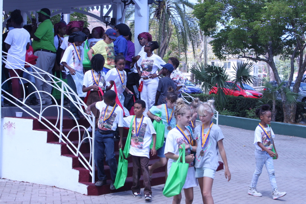 Students from a dozen schools scramble down the gazebo stairs in the Emancipation Gardens after receiving their participation medals and goodie bags. (Bethaney Lee photo)