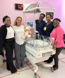 JFL Hospital staff, from left, K. Davis, RN with unit mascot “Jeffery,” J. Jeffers, RN, D. Ebbeson, RN and B. Abraham, pose with recently acquired incubator for the neonatal intensive care unit. (Submitted photo)