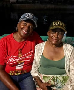 Friends Marcy George and Utah Ferguson enjoy meeting up in the village. (Source photo by Amy Roberts)