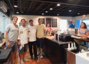 Jeff Sanford, Brandt Pell, Todd Manley and Art Wollenweber greet customers at the opening day of the Sion Farm Distillery. (Susan Ellis photo)